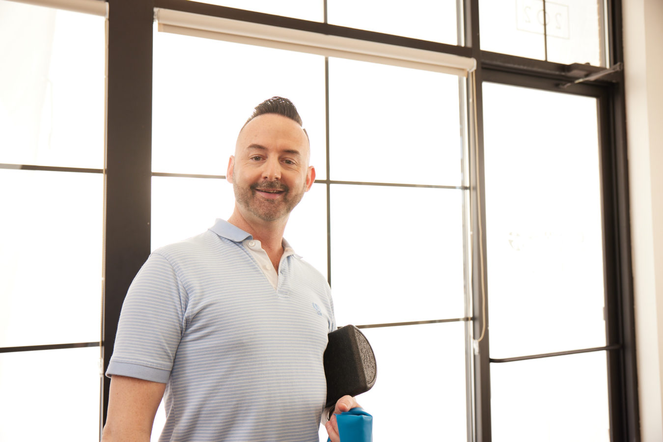 man standing in physical therapy clinic entrance