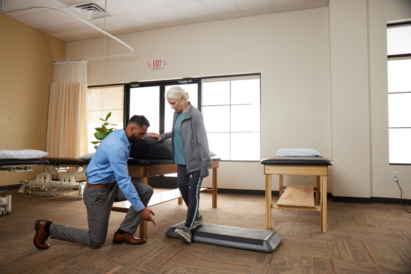 physical therapist examining a womans foot