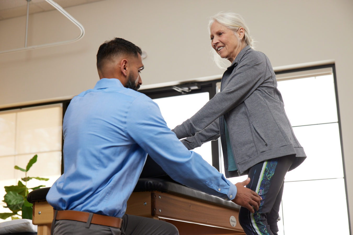 physical therapist examining older womans leg