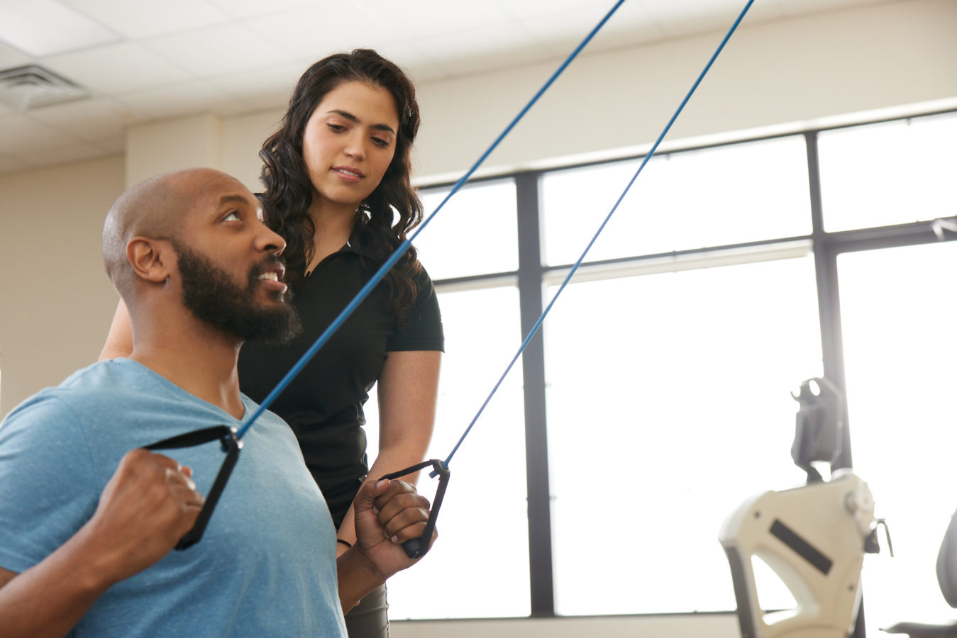 physical therapist leading patient through exercises