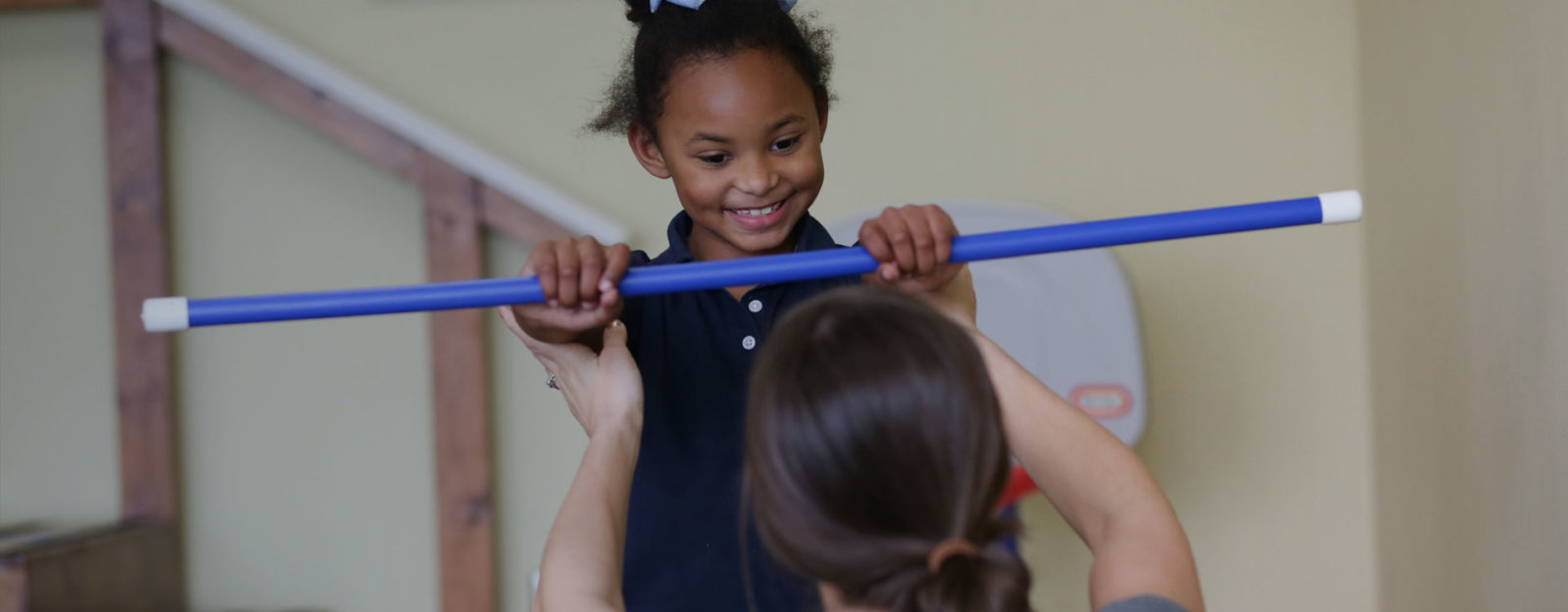 female physical therapist working with young girl during a pediatric therapy session