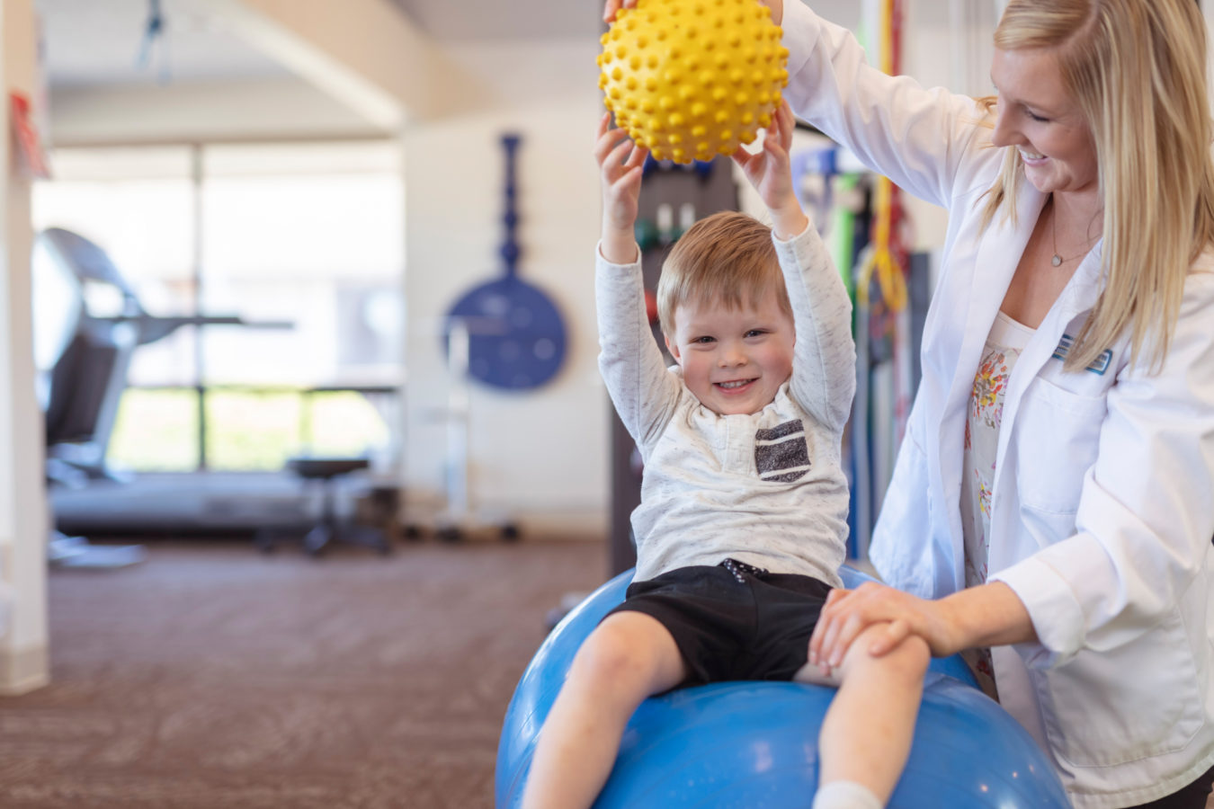 Physical therapist working with a young boy in the clinic