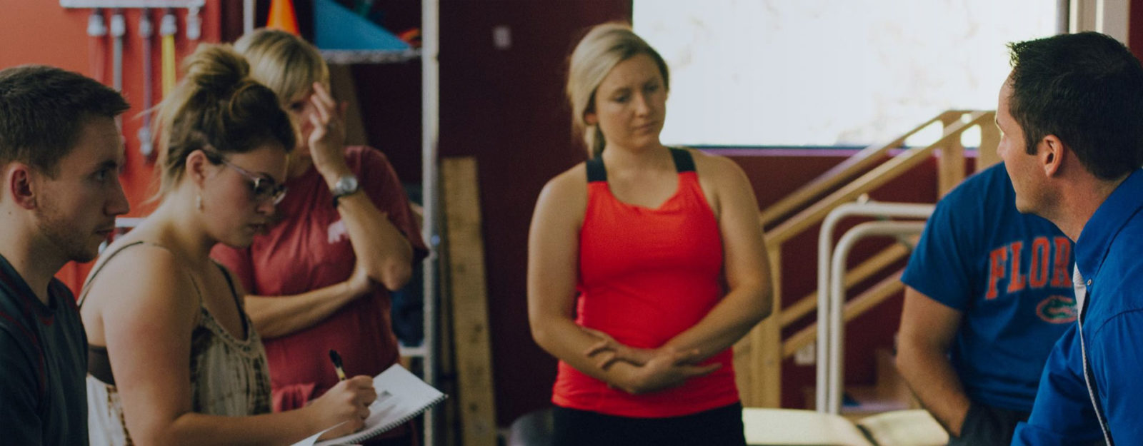 group of young female and male students training to be physical therapists