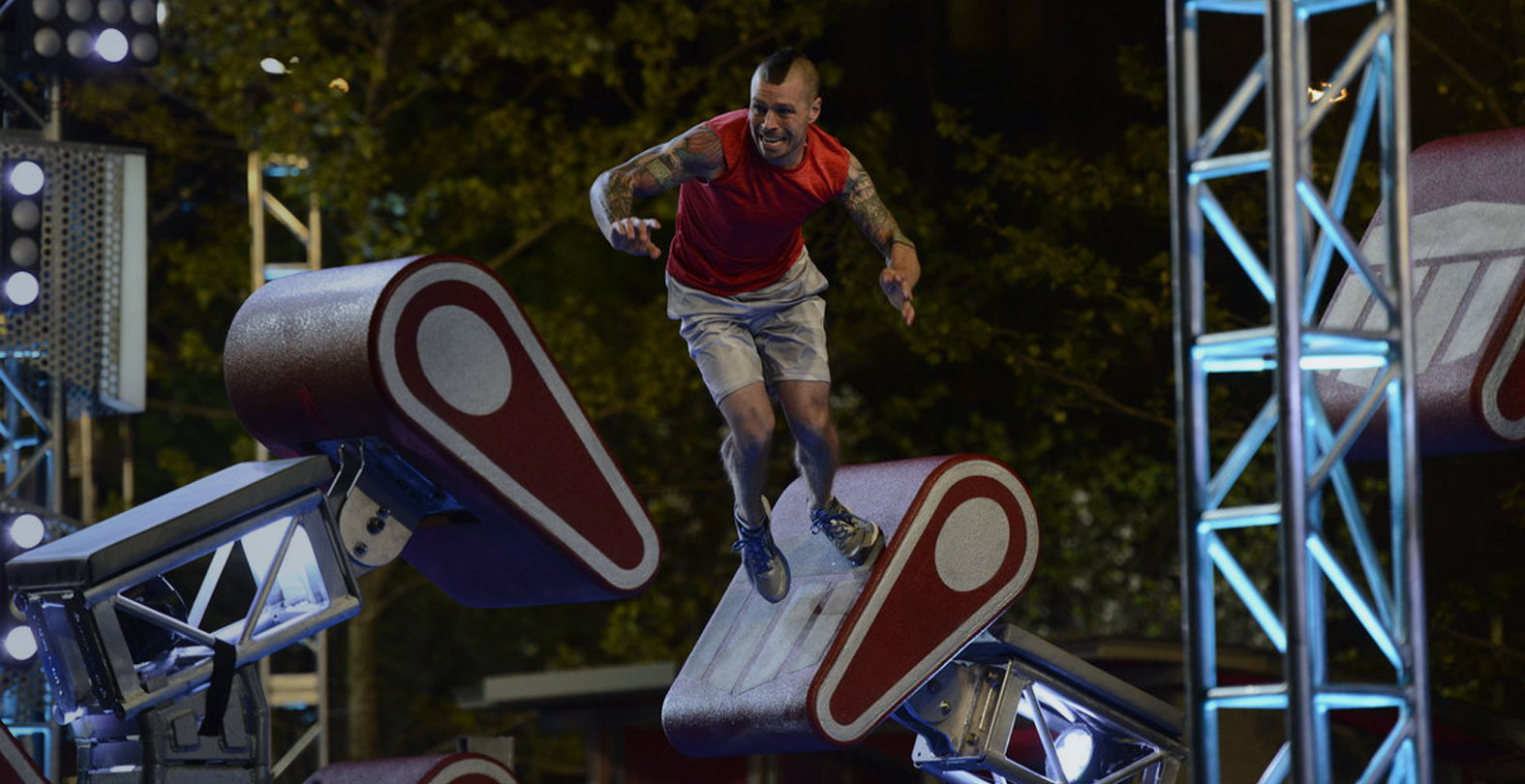 man jumping in obstacle course